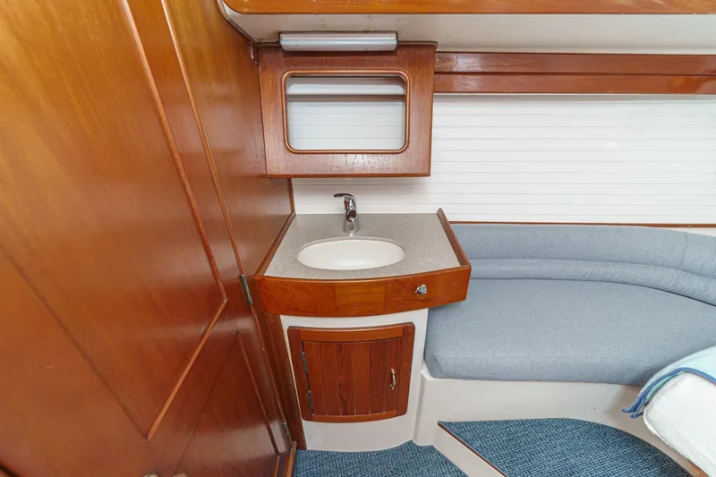 Slide: The Image of Interior of 1992 Morgan 45 Catalina yacht with wooden cabinetry and compact sink area. - 51