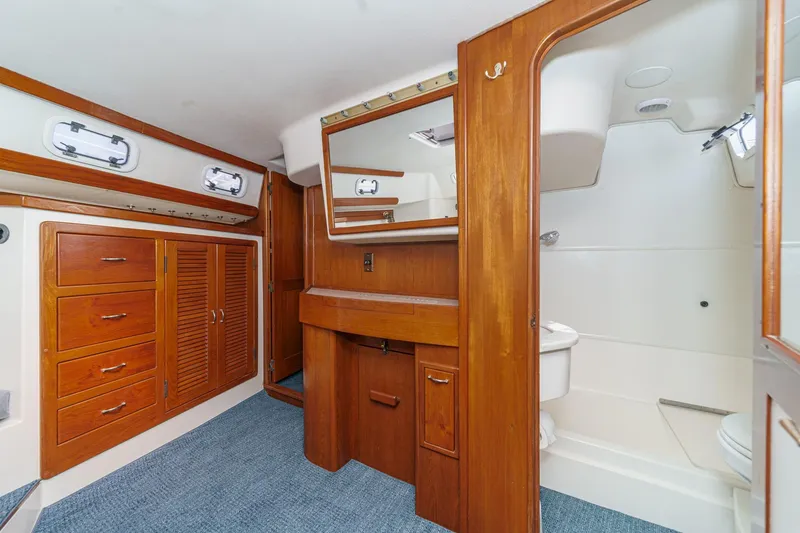 Slide: The Image of Interior of 1992 Morgan 45 Catalina yacht with wooden cabinetry and bathroom. - 52
