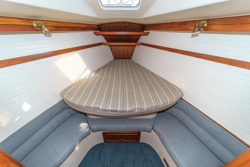 Slide: The Image of Interior cabin of 1992 Morgan 45 Catalina sailboat with cozy bedding and seating. - 55