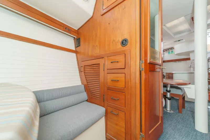 Slide: The Image of Interior of 1992 Morgan 45 Catalina yacht with wooden cabinetry and seating area. - 56