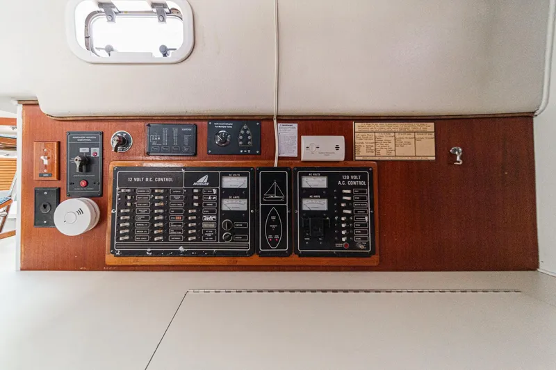 Slide: The Image of Control panel of a 1992 Morgan 45 Catalina yacht, featuring AC and DC systems. - 59