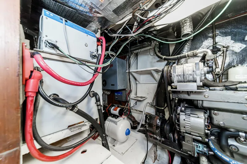 Slide: The Image of Engine room of a 1992 Morgan 45 Catalina sailboat, showcasing wiring and mechanical components. - 63