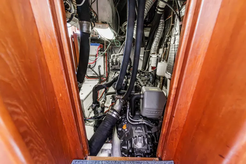 Slide: The Image of Engine room of 1992 Morgan 45 Catalina sailboat with visible machinery and wiring. - 64