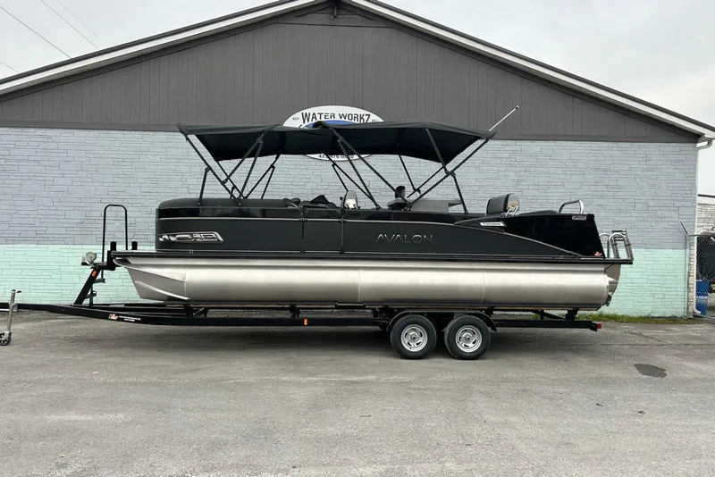 The Image of 2025 Avalon 2585 Catalina Entertainer pontoon boat on trailer, parked outside a building. - 0