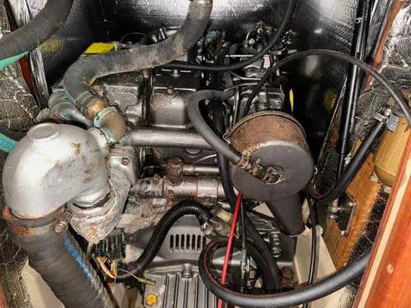 Slide: The Image of Engine compartment of a 1996 Hunter 376 sailboat, showing hoses and mechanical components. - 3