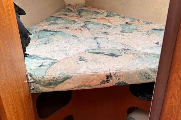Slide: The Image of Cozy cabin interior of 1996 Hunter 376 sailboat with patterned bedding. - 7