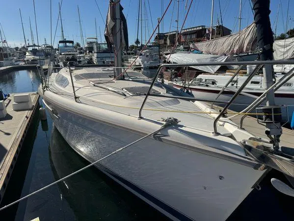 Slide: The Image of Sailboat docked in marina, 1996 Hunter 376 model, surrounded by other boats. - 9