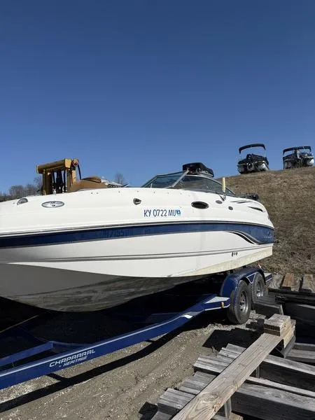 The Image of 2005 Chaparral SUNSESTA boat on trailer under clear blue sky. - 1