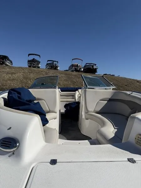 Slide: The Image of 2005 Chaparral SUNSESTA boat interior with seating, under clear blue sky. - 4