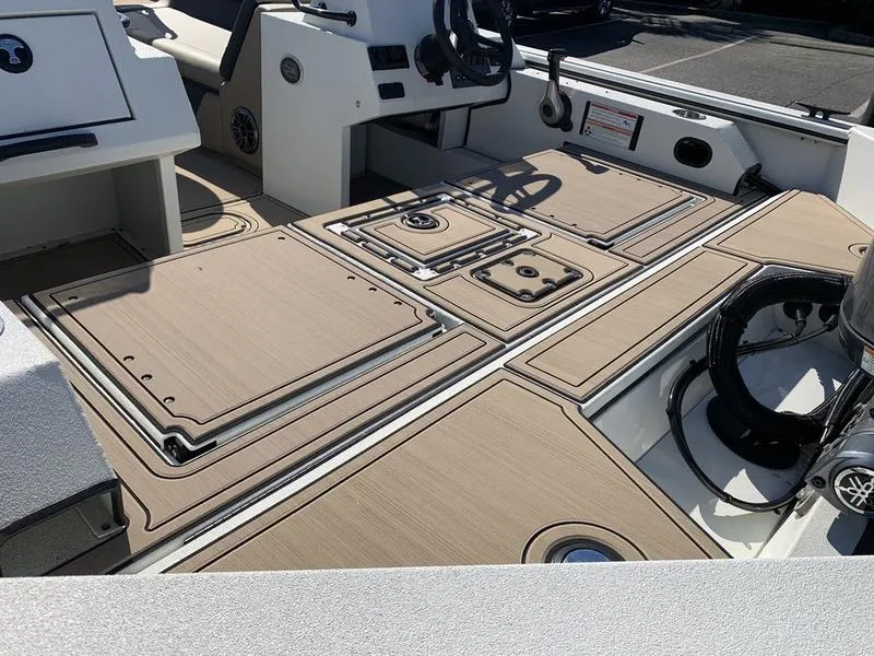 Slide: The Image of 2025 SeaArk Easy 200 boat interior with sleek, modern deck design and storage compartments. - 11