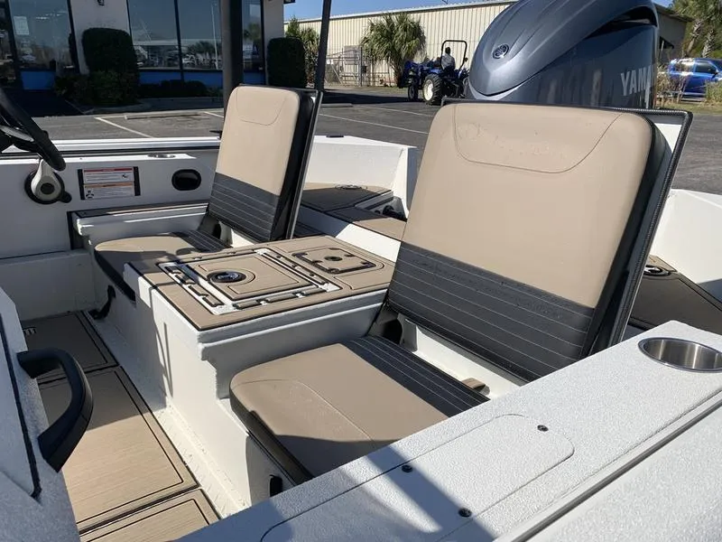 Slide: The Image of 2025 SeaArk Easy 200 boat interior with beige seating and Yamaha engine. - 12