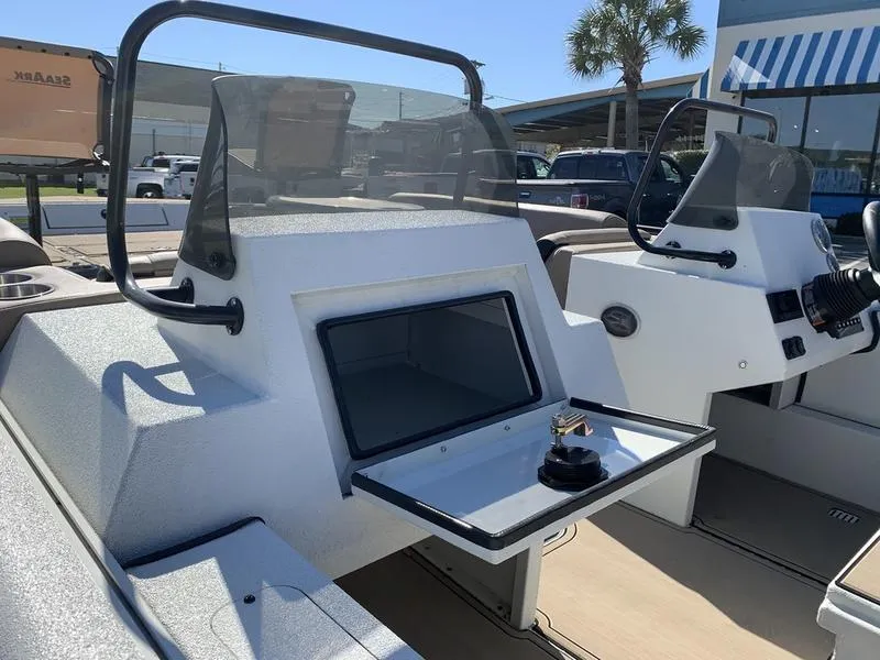 Slide: The Image of 2025 SeaArk Easy 200 boat interior with open storage compartment and windshield. - 13