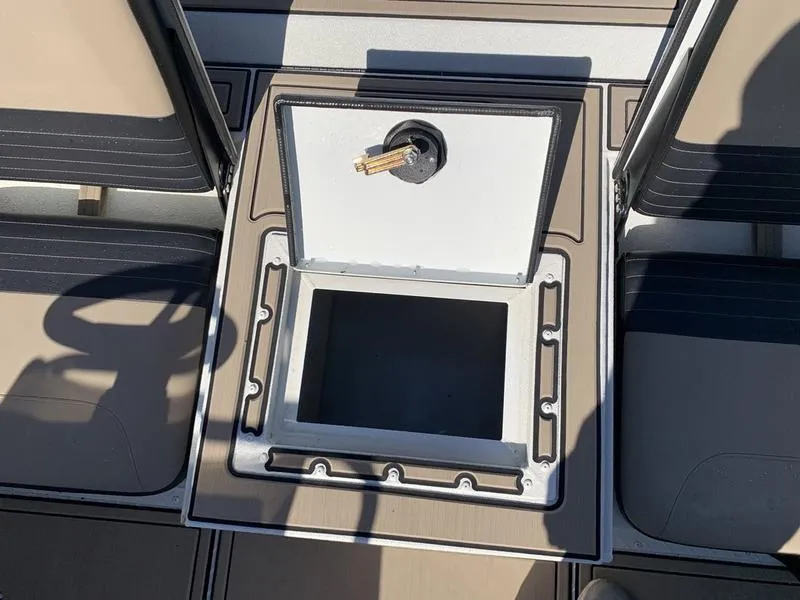Slide: The Image of 2025 SeaArk Easy 200 boat storage compartment with open lid and seating area. - 14