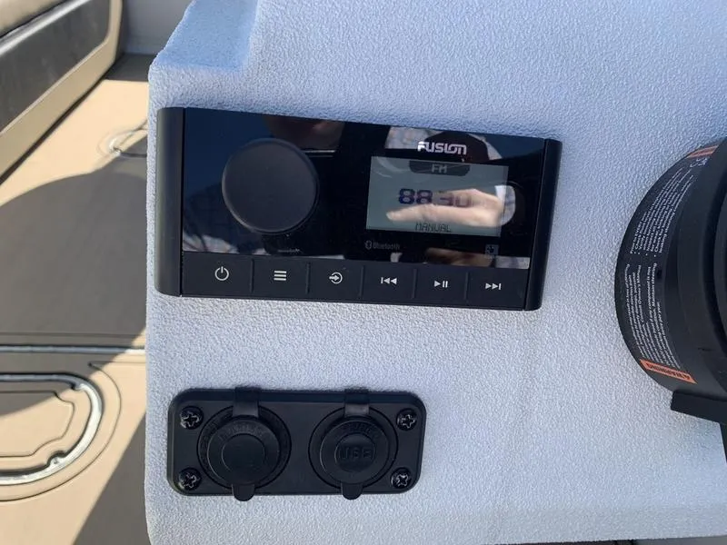 Slide: The Image of 2025 SeaArk Easy 200 boat dashboard with Fusion stereo system and USB ports. - 16
