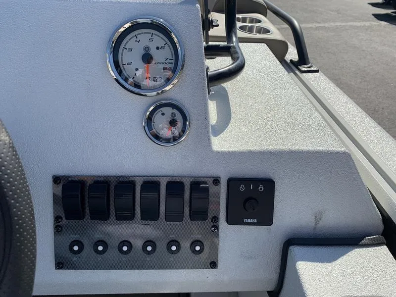 Slide: The Image of Control panel of 2025 SeaArk Easy 200 boat with gauges and switches. - 17