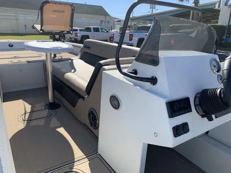 Slide: The Image of 2025 SeaArk Easy 200 boat interior with seating, steering console, and mounted table. - 19