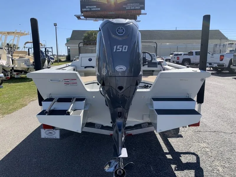 Slide: The Image of 2025 SeaArk Easy 200 boat with 150 HP outboard motor, parked outdoors. - 2