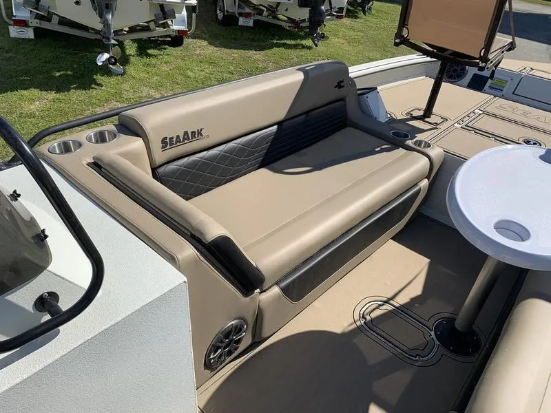 Slide: The Image of 2025 SeaArk Easy 200 boat interior with beige seating and cup holders. - 20