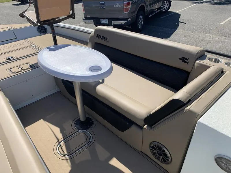 Slide: The Image of 2025 SeaArk Easy 200 boat interior with seating and table, parked in a lot. - 22