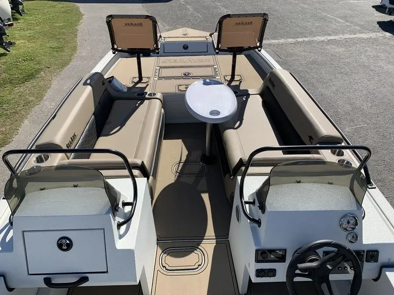 Slide: The Image of 2025 SeaArk Easy 200 boat interior with seating, table, and dual consoles. - 24