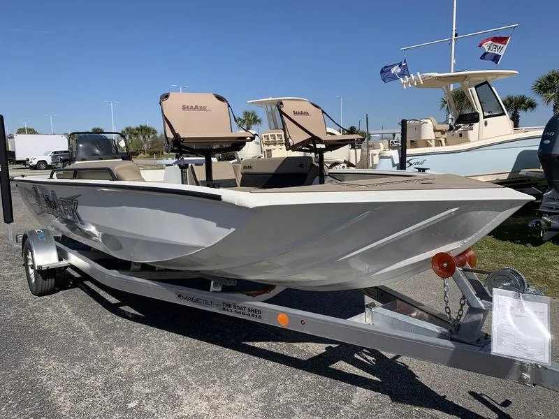 Slide: The Image of 2025 SeaArk Easy 200 boat on trailer, parked outdoors under clear sky. - 5