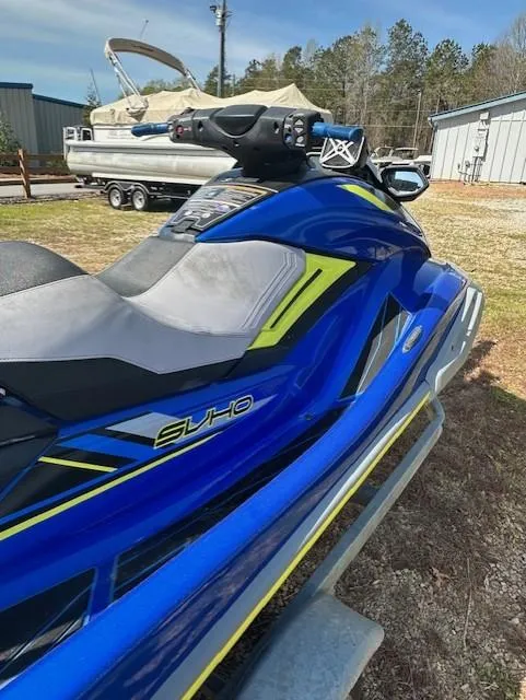 Slide: The Image of 2020 Yamaha WaveRunner FX Cruiser SVHO in blue, parked outdoors near boats. - 4