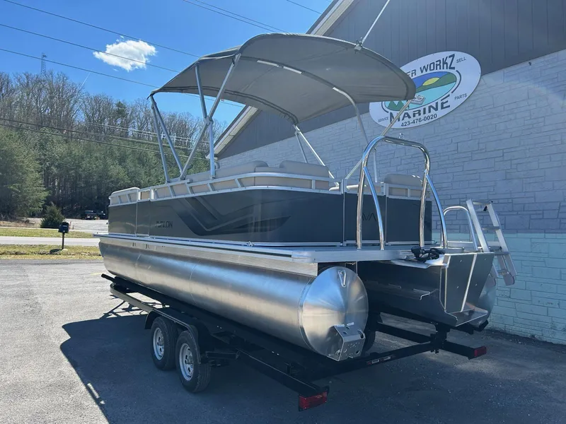 Slide: The Image of 2025 Avalon 2380 VLS Quad Lounger pontoon boat on trailer, parked outdoors. - 3