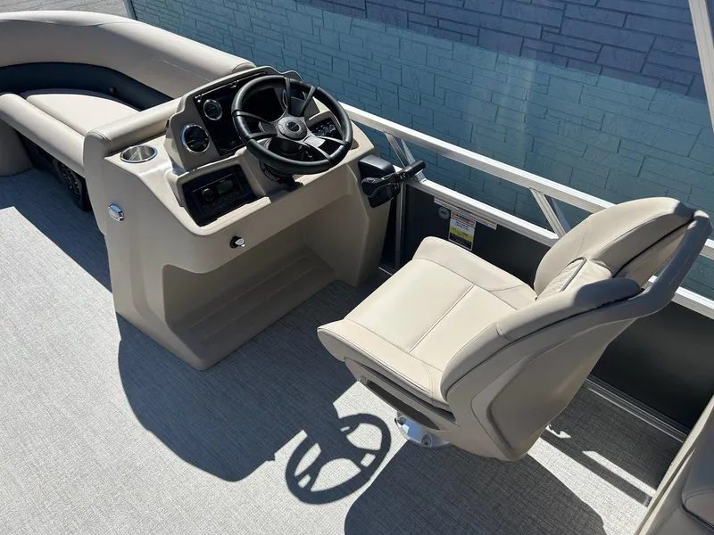 Slide: The Image of 2025 Avalon 2380 VLS Quad Lounger boat interior with steering console and captain's chair. - 8
