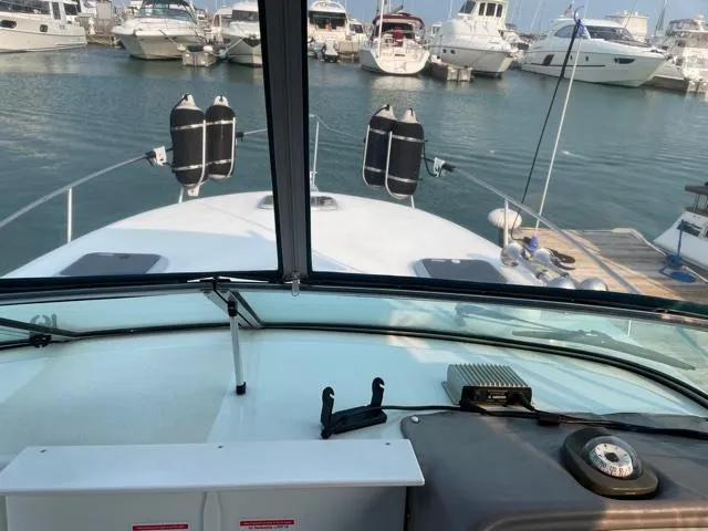 Slide: The Image of 1994 Rinker Fiesta Vee 265 boat docked at marina, view from cockpit. - 11