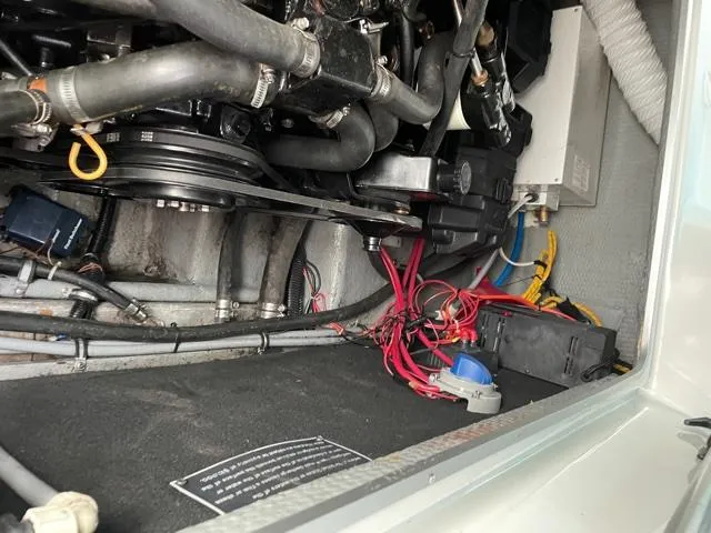 Slide: The Image of Engine compartment of a 1994 Rinker Fiesta Vee 265 boat, showing wiring and components. - 13
