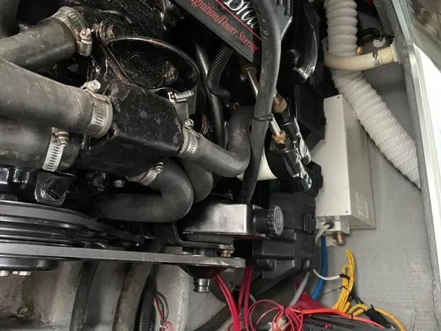 Slide: The Image of Engine compartment of a 1994 Rinker Fiesta Vee 265 boat, showing hoses and wiring. - 15
