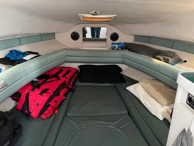 Slide: The Image of Interior cabin of 1994 Rinker Fiesta Vee 265 boat with seating and storage. - 18