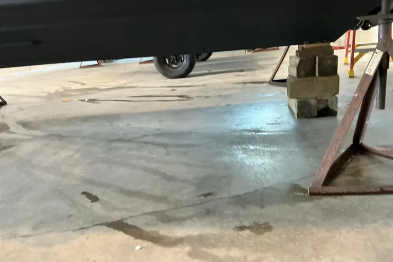 Slide: The Image of 1994 Rinker Fiesta Vee 265 boat on stands in a garage setting. - 27