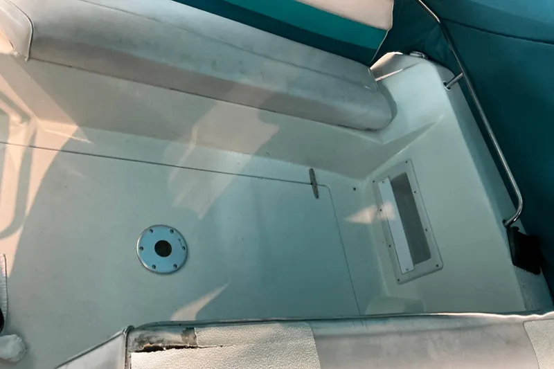 Slide: The Image of Interior view of a 1994 Rinker Fiesta Vee 265 boat, featuring seating and deck area. - 32