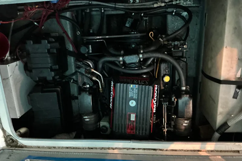 Slide: The Image of Engine compartment of a 1994 Rinker Fiesta Vee 265 boat, featuring a MerCruiser engine. - 35