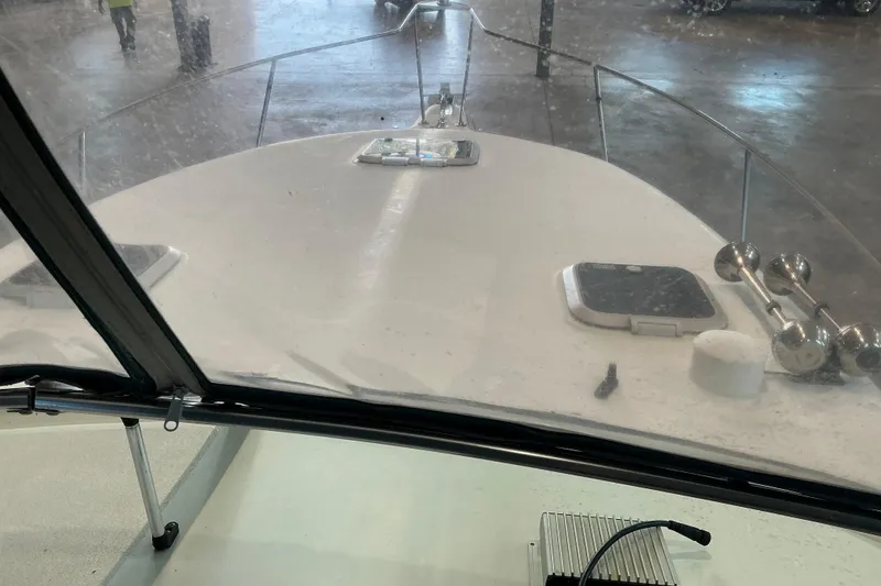 Slide: The Image of 1994 Rinker Fiesta Vee 265 boat interior view with windshield and deck details. - 37