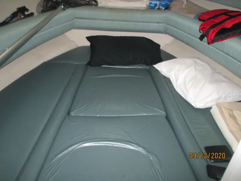 Slide: The Image of Interior cabin of 1994 Rinker Fiesta Vee 265 with cushions and pillows. - 4