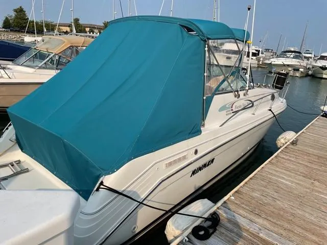 Slide: The Image of 1994 Rinker Fiesta Vee 265 boat docked with teal canopy cover. - 5