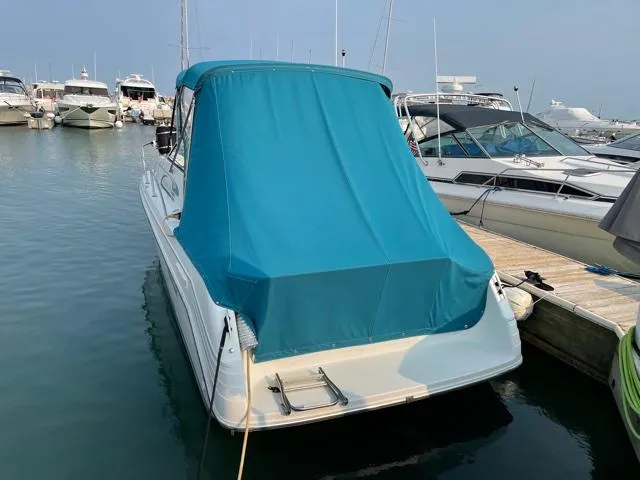 Slide: The Image of 1994 Rinker Fiesta Vee 265 boat docked with blue cover in marina. - 6