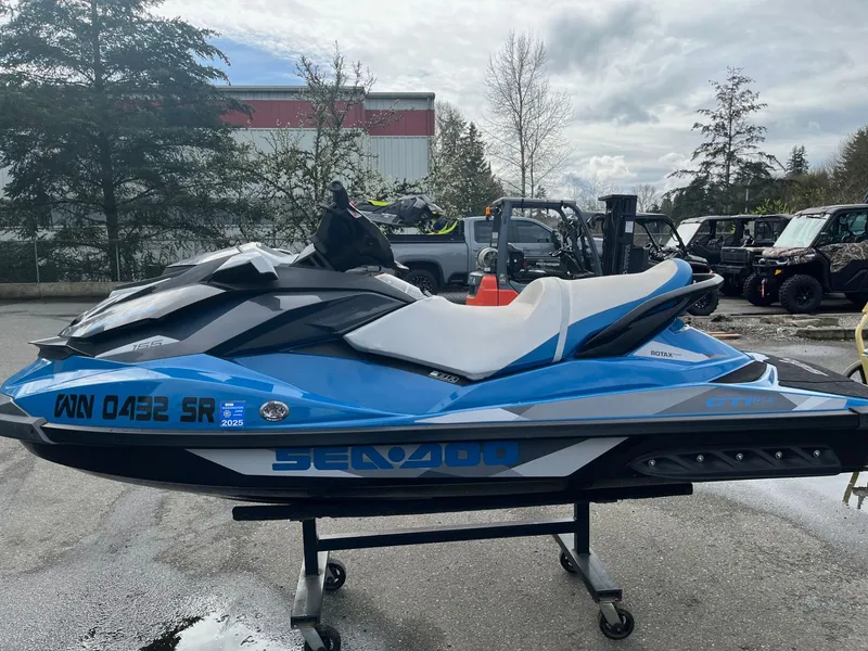 Slide: The Image of 2018 Sea-Doo GTI SE 155 jet ski in blue and white, parked outdoors. - 4