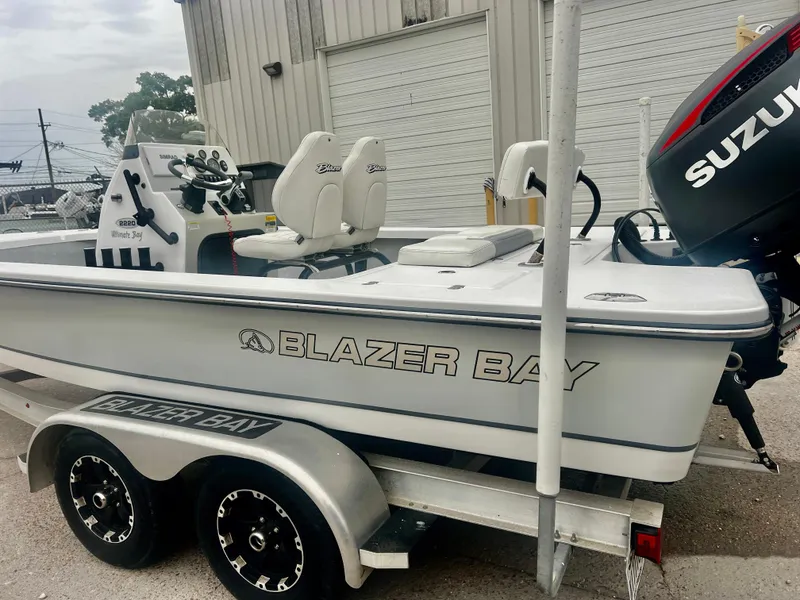 Slide: The Image of 2015 Blazer Bay 2220 GTS boat on trailer with Suzuki outboard motor. - 10