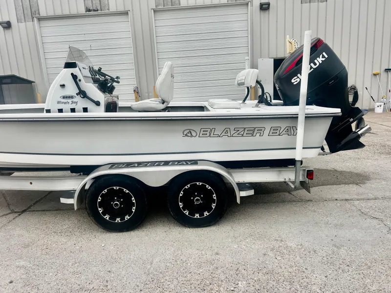 Slide: The Image of 2015 Blazer Bay 2220 GTS boat on trailer with Suzuki outboard motor. - 11