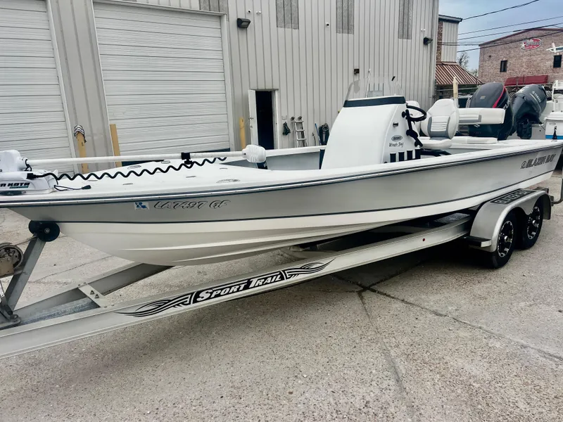 Slide: The Image of 2015 Blazer Bay 2220 GTS boat on trailer, parked outside industrial building. - 12