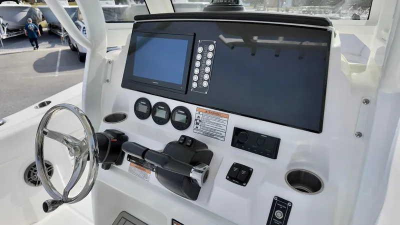 Slide: The Image of 2025 Sea Fox 268 Commander boat dashboard with steering wheel and navigation controls. - 9
