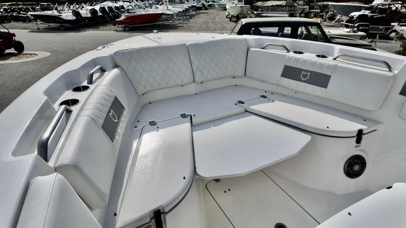 Slide: The Image of 2025 Sea Fox 268 Commander boat interior with white cushioned seating and storage compartments. - 6