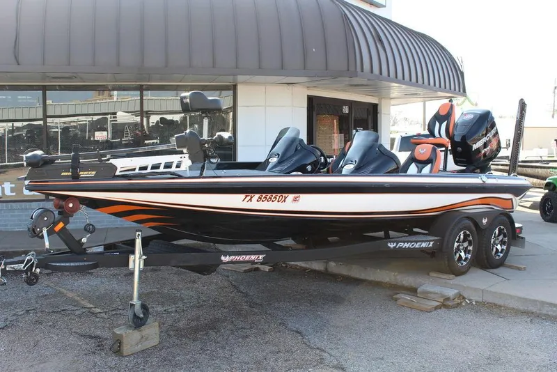 Slide: The Image of 2018 Phoenix 721 ProXP boat on trailer, parked outside a building. - 1
