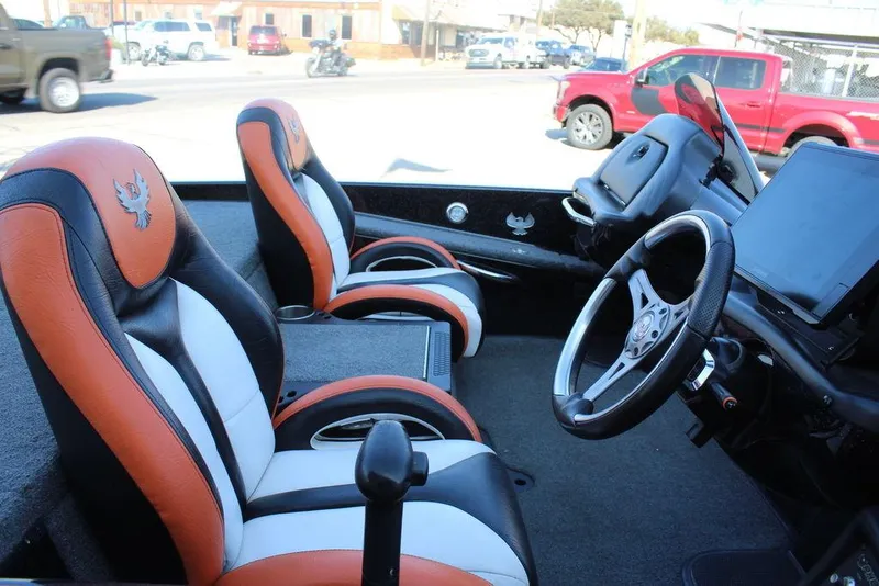Slide: The Image of 2018 Phoenix 721 ProXP boat interior with orange and black seats, steering wheel, and dashboard. - 10