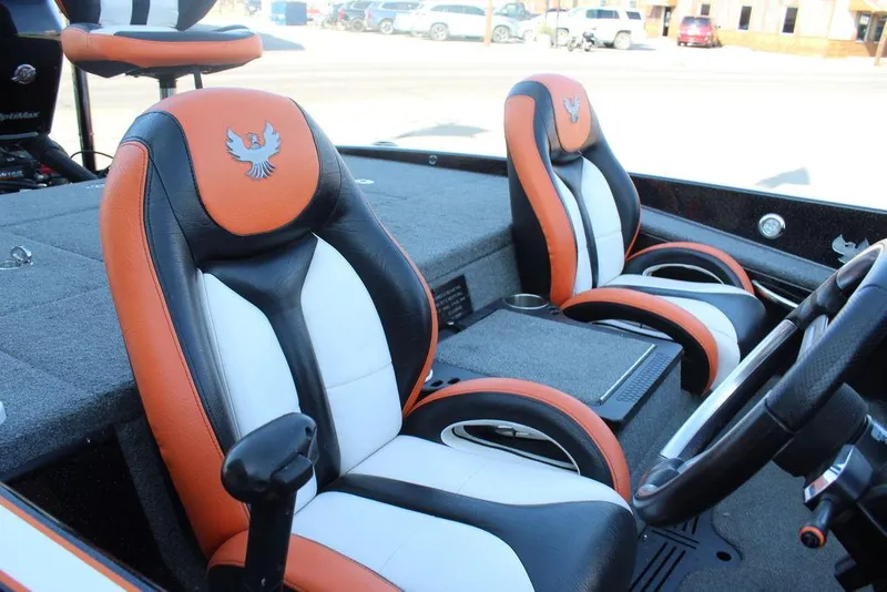 Slide: The Image of 2018 Phoenix 721 ProXP boat interior with orange and black seats, featuring a steering wheel. - 11