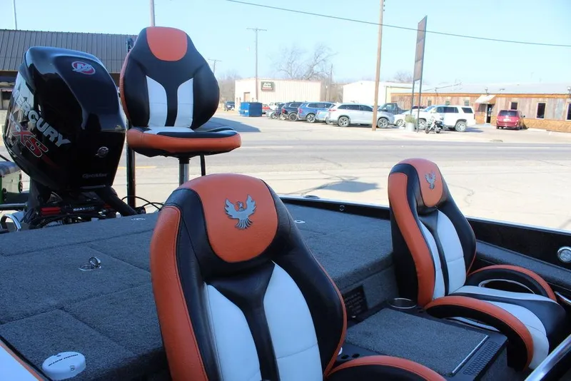 Slide: The Image of 2018 Phoenix 721 ProXP boat with orange and black seats, parked outdoors. - 12
