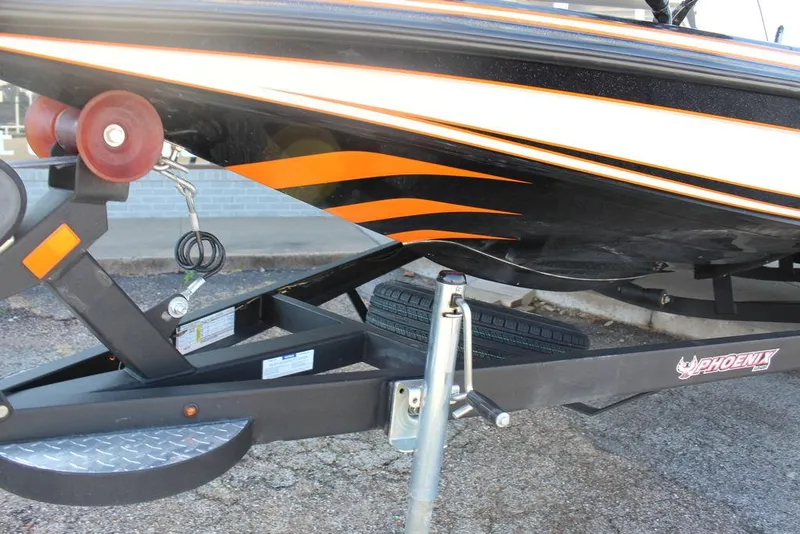 Slide: The Image of 2018 Phoenix 721 ProXP boat on trailer with orange and black design. - 18